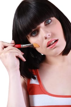 Woman putting on makeup