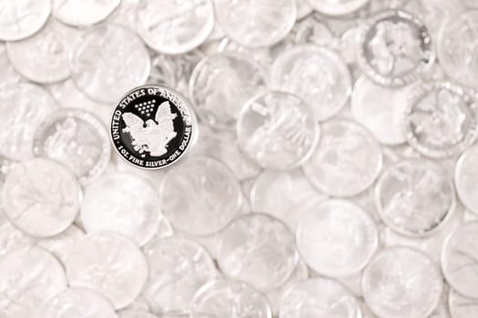 Silver eagle, one dollar coin on blurred money background