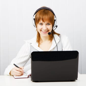 girl in headphones with a microphone. Worker Hotline