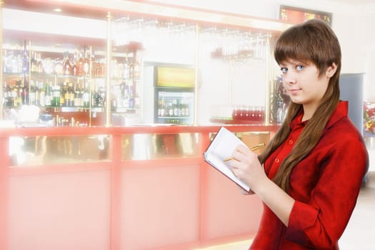 girl in red blouse with a notebook on the background of the bar