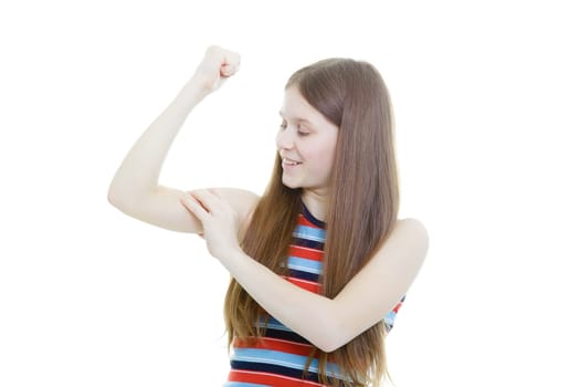 smiling teenage girl measuring her biceps on a white background