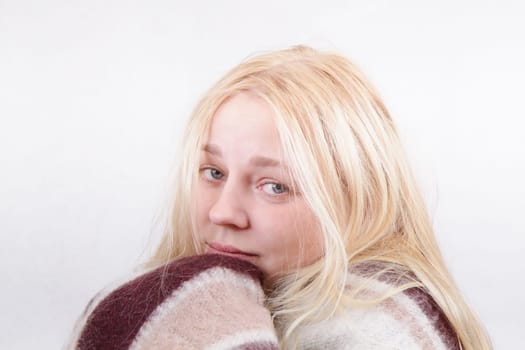 sad sick girl wrapped in a blanket