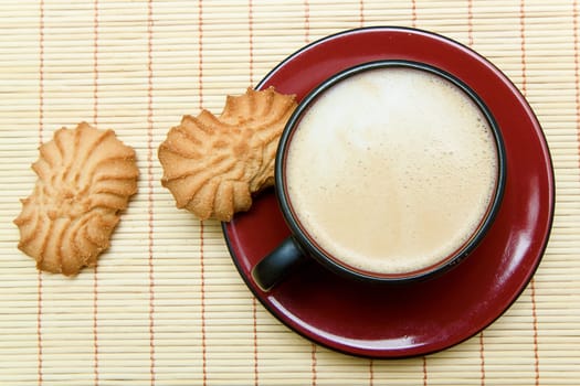 cup of cappuccino and cookies on a saucer