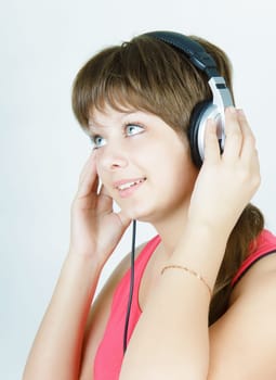 beautiful smiling girl teenager in the headphones