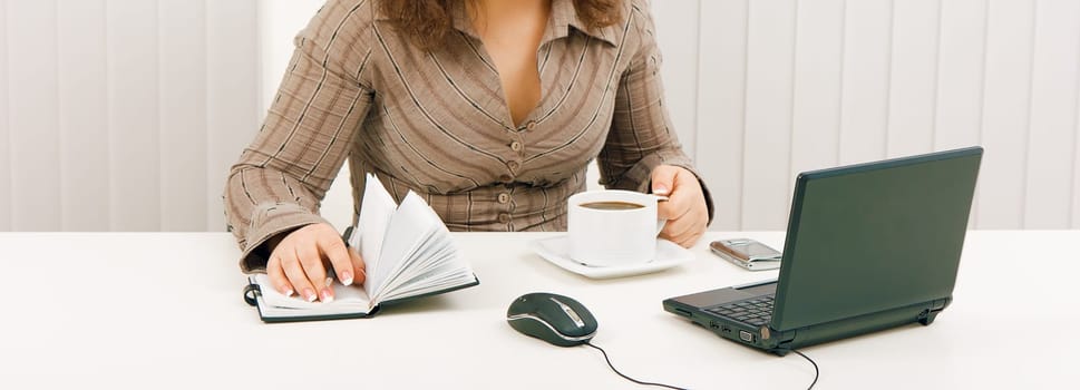 employee in the office with a black laptop
