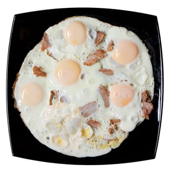 scrambled eggs with bits of meat on a black square plate
