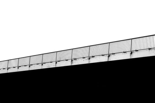The monochrome photograph of a bridge railing.