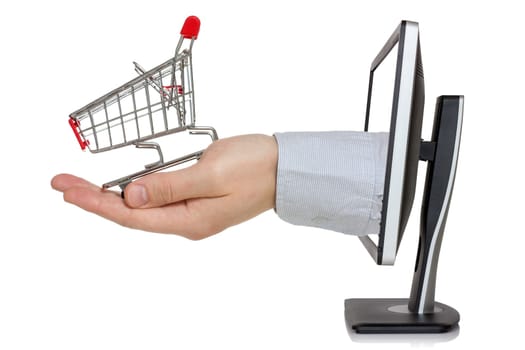 E-commerce conception. Computer monitor and hand with shopping cart