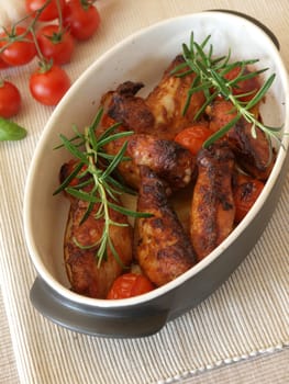Spicy chicken wings in a creamic bowl with herbs
