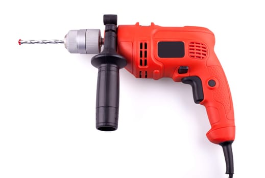Orange electric drill with handle isolated on white background.
