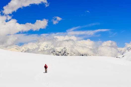 Mountain trekker walking in high winter Himalayas mountains, Nepal