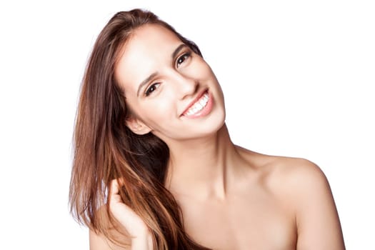 Beautiful happy smiling woman showing teeth with great skin touching her hair, skincare and haircare concept, isolated.
