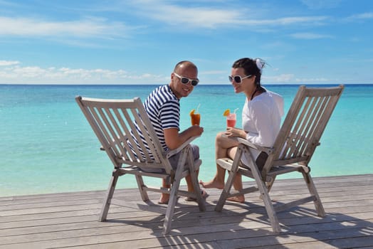 happy young couple relax and take fresh drink at summer vacation