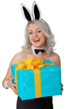 Laughing blonde woman with rabbit ears and a gift box isolated on white background
