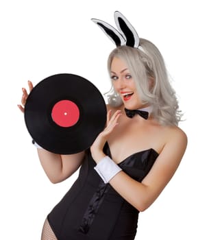 Playful blonde in a bunny suit with a vinyl record in the hands isolated on white background