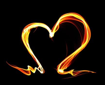 Orange fire heart isolated on black background