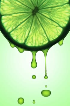 Slice of lemon with juice drops falling.