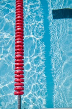 Closeup of red lane rope in swimming pool