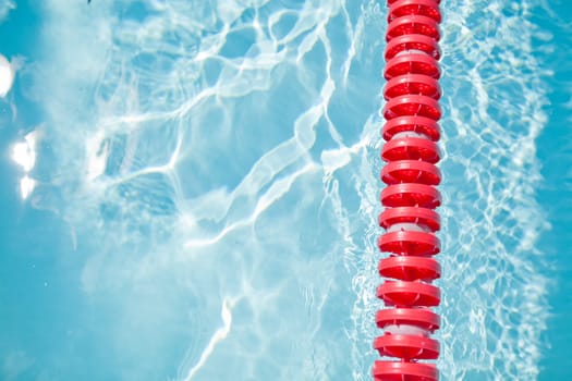 Closeup of red lane rope in swimming pool