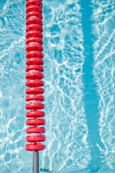 Closeup of red lane rope in swimming pool