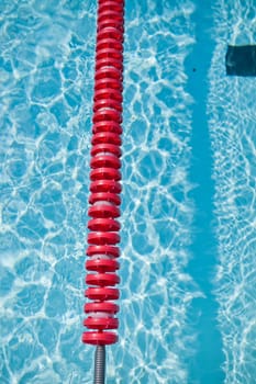 Closeup of red lane rope in swimming pool
