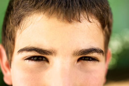 Young people and emotions, portrait of serious kid looking at camera. Closeup of eyes