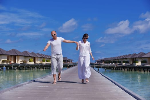 happy young couple have fun and relax at summer vacation on background maldives travel location and beautiful white sand beach
