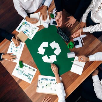 Top view business people planning and discussing on recycle reduce reuse policy symbol in office meeting room. Green business company with eco-friendly waste management regulation concept.Trailblazing