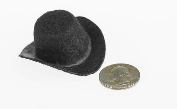 Cowboy hat and old coin close up over white background