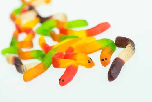 Gummy worms close up over white background
