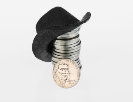 American nickel close up with black cowboy hat on a stack of nickels