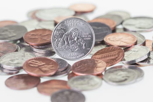 2008 Alaska State Quarter with other coins extreme close up