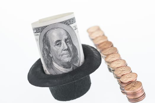 One hundred dollar note in a hat over white