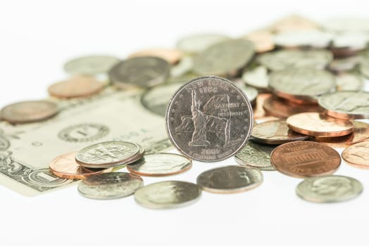 New York State Quarter with one dollar bill and coins close up