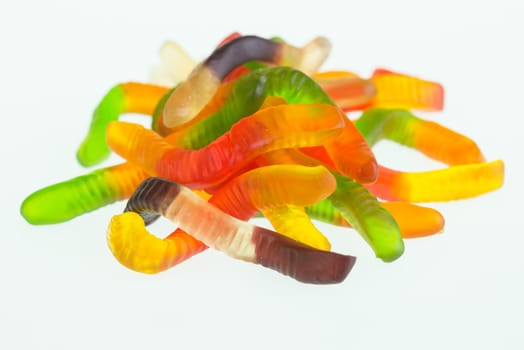 Gummy worms close up over white background