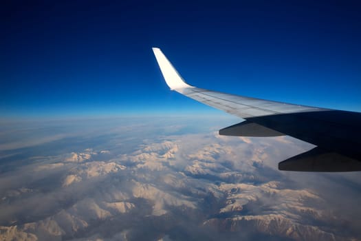 aircraft flying over snowed mountains of Pyrenees between France and Spain