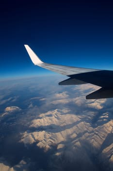 aircraft flying over snowed mountains of Pyrenees between France and Spain