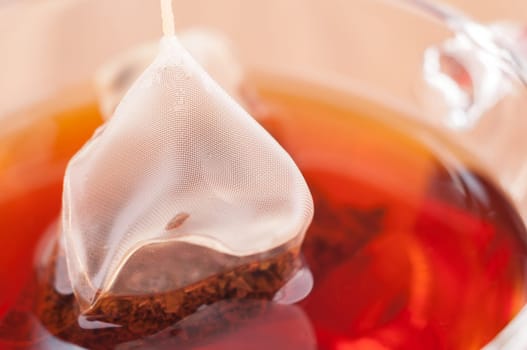Pyramid mesh tea bag in a cup close up