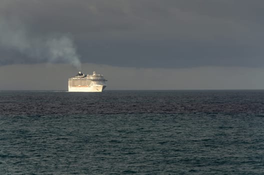 cruise ship at sunrise on the sea with black sky