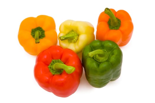 Five paprikas in five different colors isolated on white background