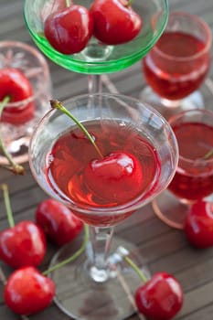 Cherry liquor in small jars with fresh cherries