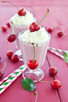 Two Glser with milkshake with fresh cherries