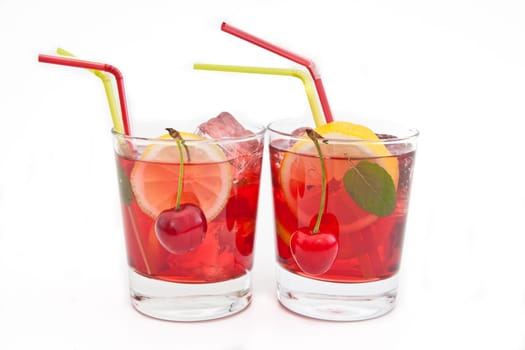 Homemade lemonade with fresh lemons and cherries on white