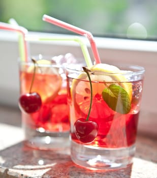 Homemade lemonade with fresh lemons and cherries