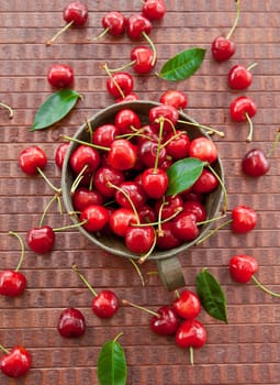 Fresh cherries in old-fashioned copper cup