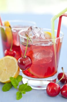 Homemade lemonade with fresh lemons and cherries