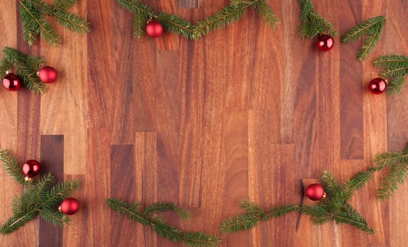 christmas decorations with fir, christmas balls and lumber with copy space in the middle