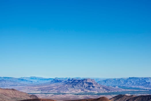 Jebel Kissane Mountains with Draa Valley against clear blue sky, Morocco.