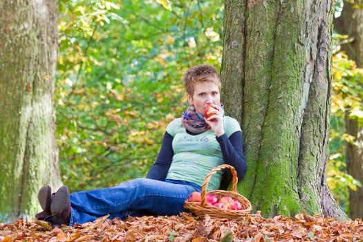 woman with a basket full of red apples