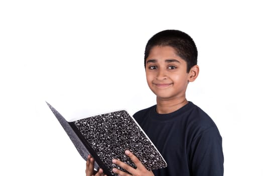 An handsome Indian kid doing his homework diligently